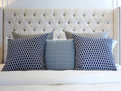 pillows on modern black and white bed in bedroom at home.
